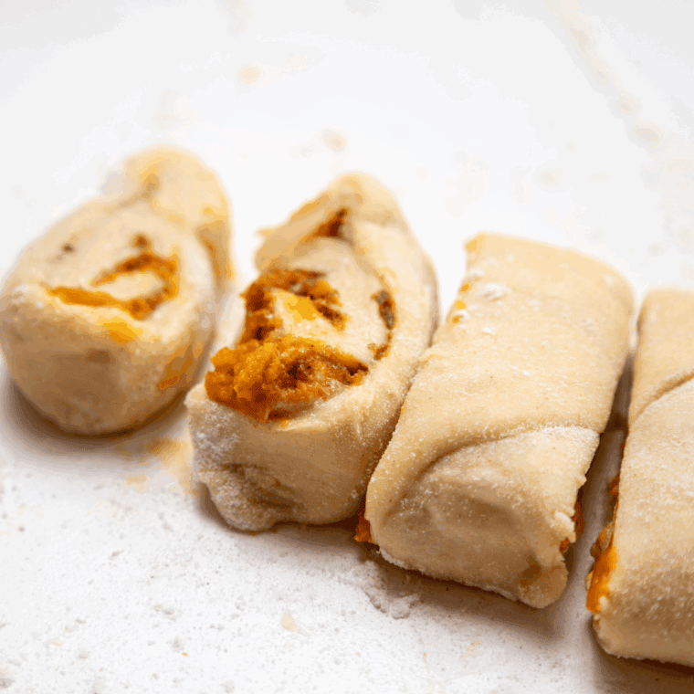 Cut the Sourdough Pumpkin Cinnamon Rolls into pieces.