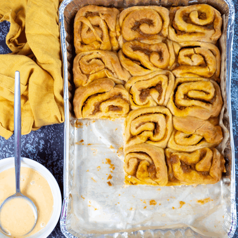 Baked Sourdough Pumpkin Cinnamon Rolls in a baking pan.