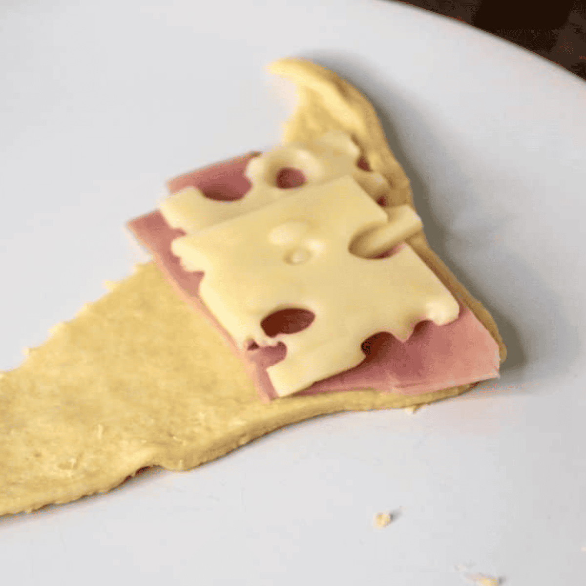 Place cheese and ham in the crescent dough.