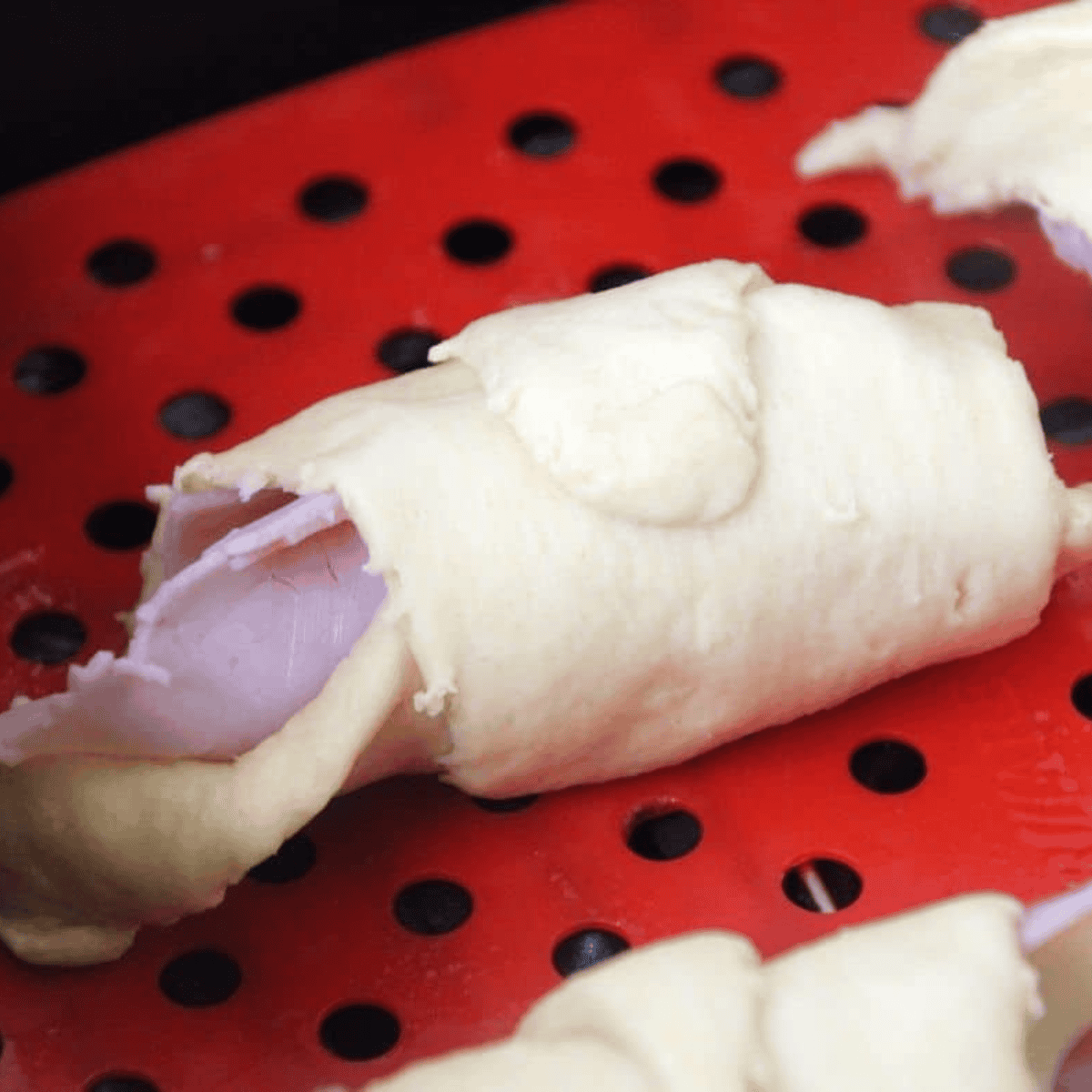 Place Starbucks Copycat Ham & Swiss Croissant Recipe in the air fryer basket.