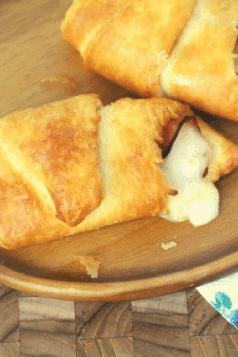 Flaky ham and Swiss croissant roll-ups cooked in the air fryer, served golden brown and melty.
