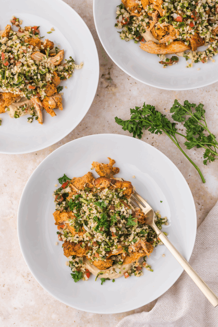 Trader Joe’s Shawarma Chicken Bowls featuring air-fried chicken, cauliflower tabbouleh, and hummus in a bowl ready to serve.