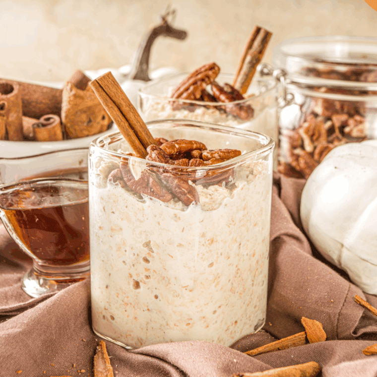 Jar of creamy applesauce overnight oats topped with apple slices and sprinkled with cinnamon