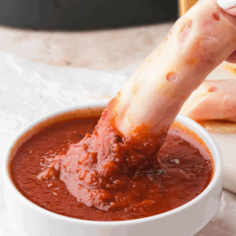Homemade Arby’s Marinara Sauce in a white bowl with herbs on top