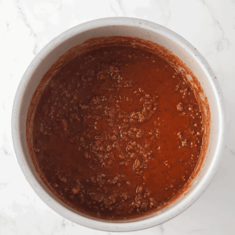  Simmering marinara sauce in a saucepan with spices and tomato paste for a rich, flavorful dip.