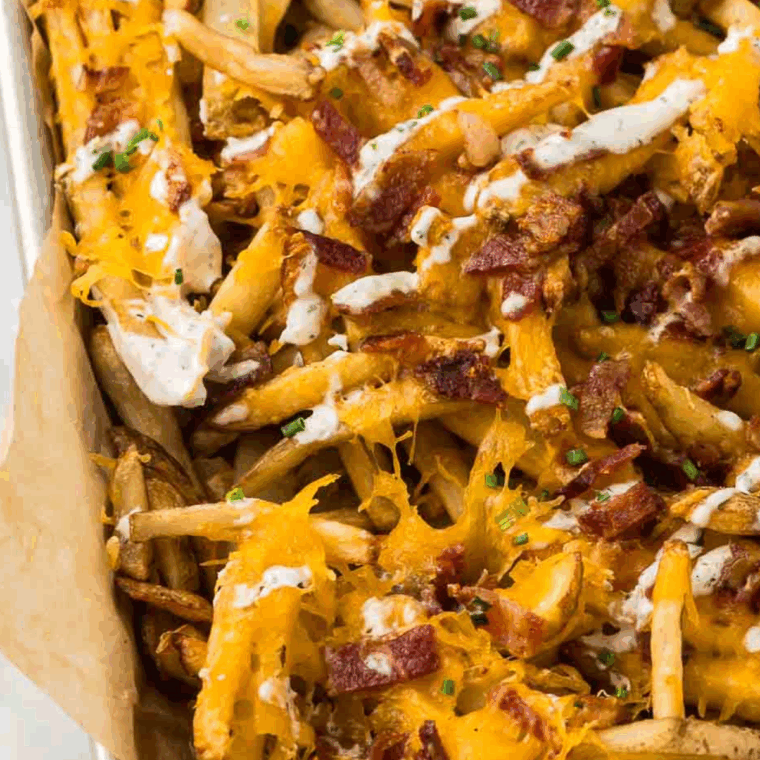 Close-up of creamy Arby’s ranch dressing with fresh herbs and dipping fries