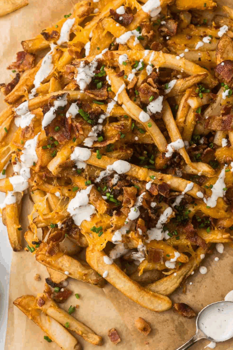 Homemade Arby’s ranch dressing in a bowl surrounded by fries and chicken tenders