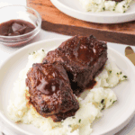 Homemade Arby’s Tangy BBQ Sauce in a bowl with a brush.