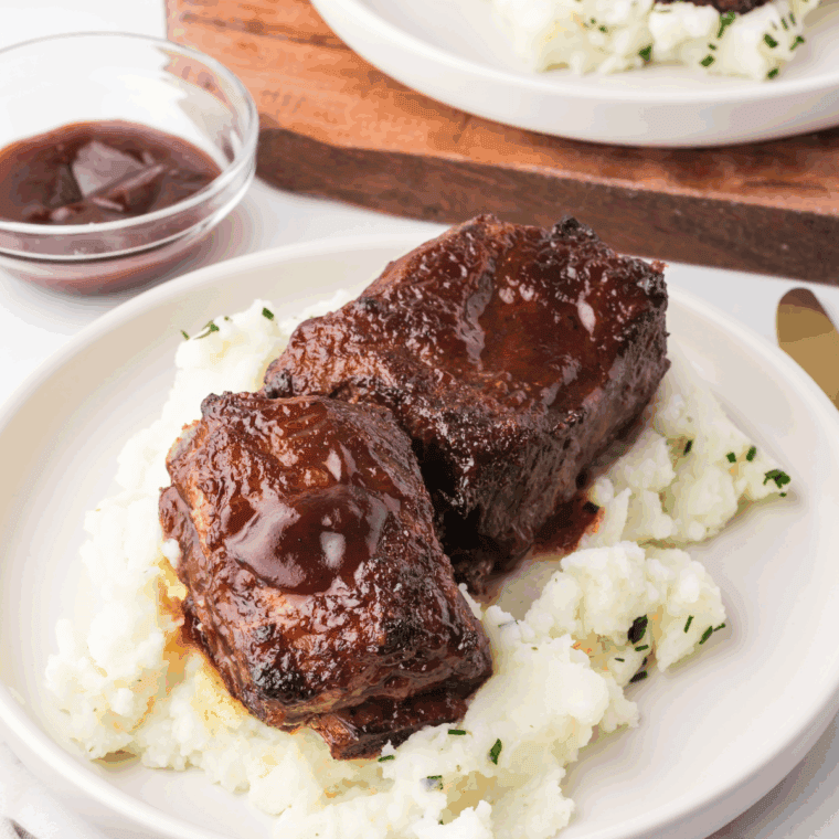 Homemade Arby’s Tangy BBQ Sauce in a bowl with a brush.
