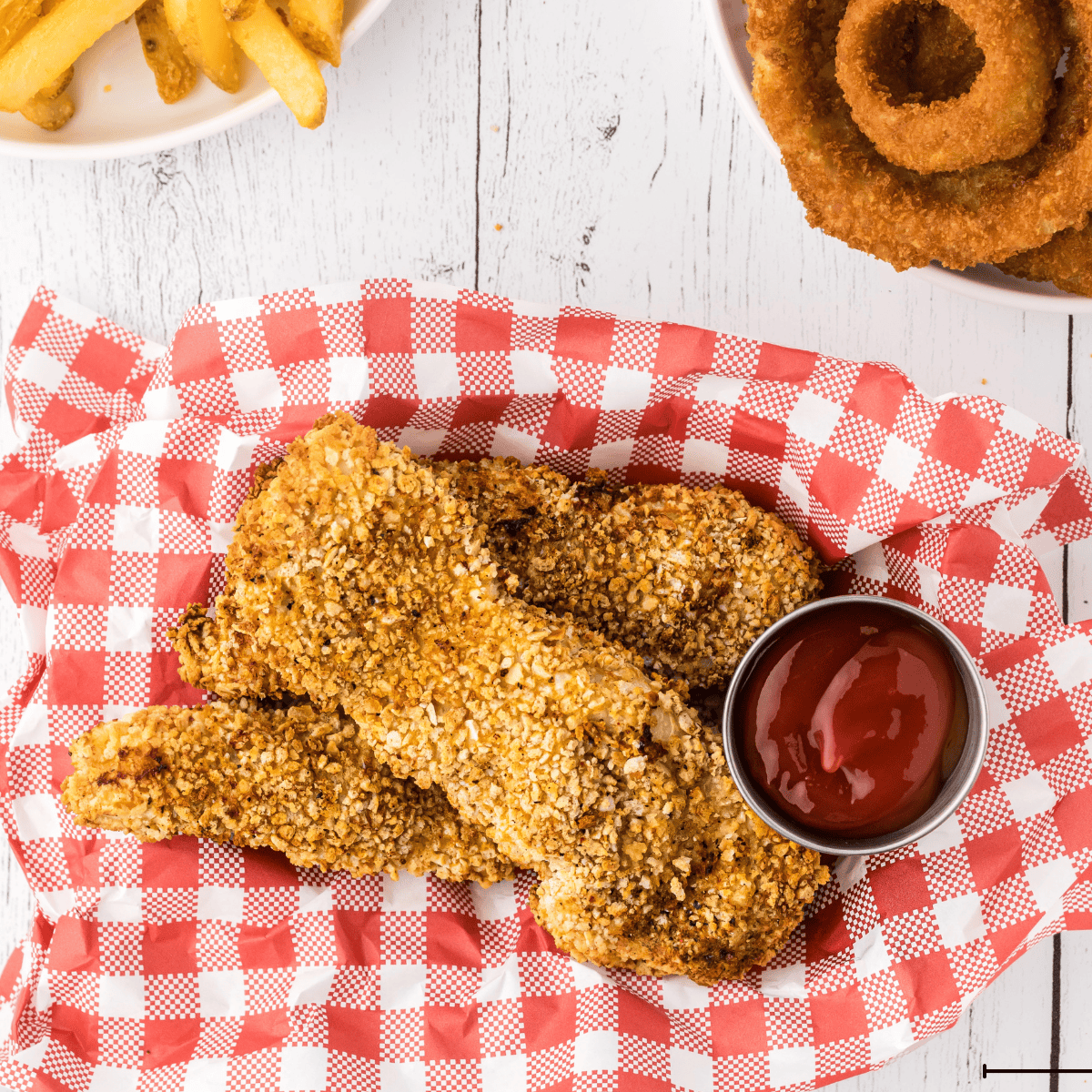 Plate of golden, crispy Arthur Treacher’s style fried chicken with dipping sauce.