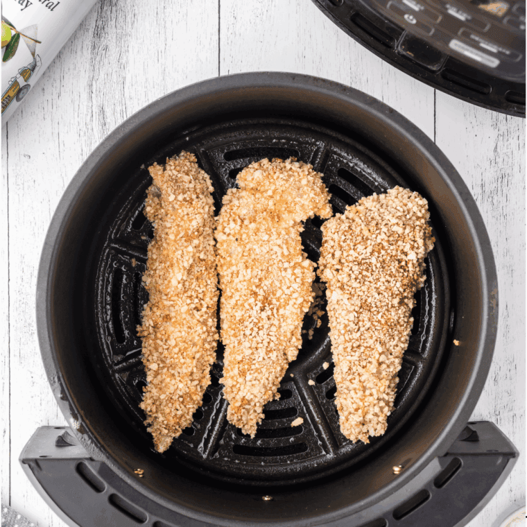 Uncooked Arthur Treacher's Chicken strips in the air fryer basket.