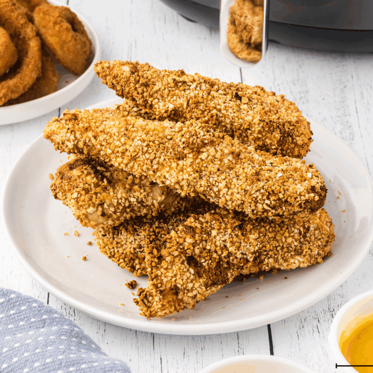 Crispy golden Arthur Treacher’s Chicken served on a plate with dipping sauce.