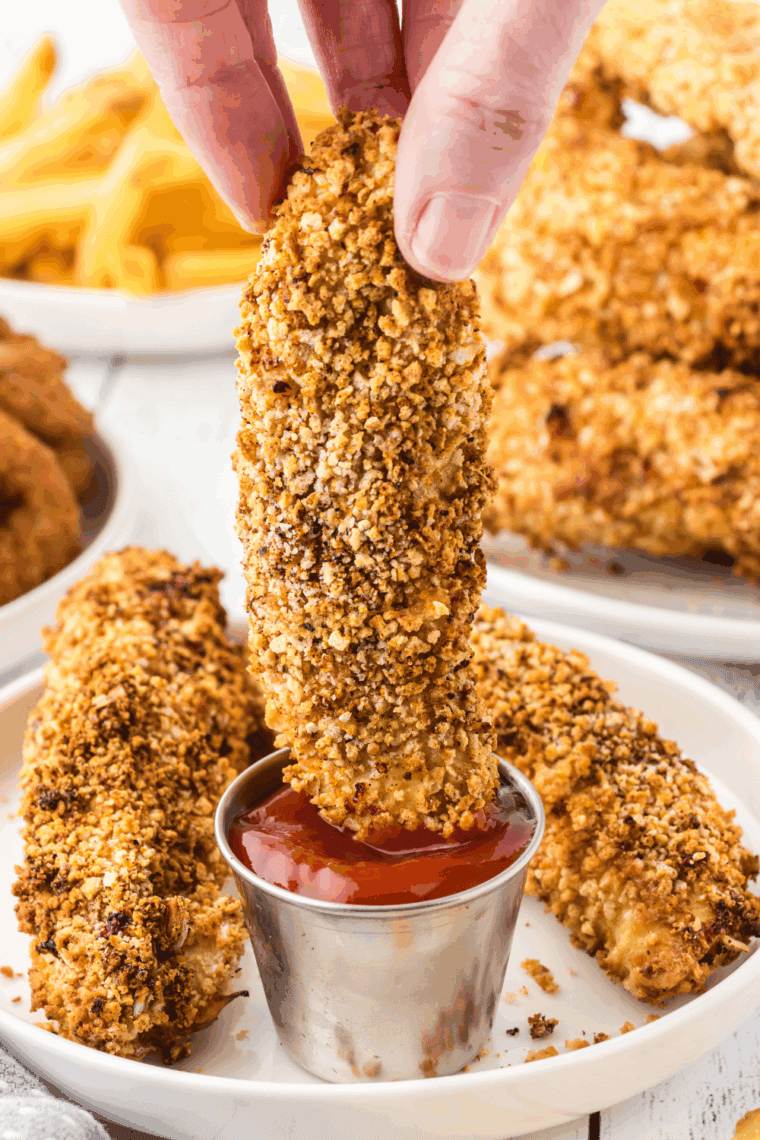 Golden crispy Arthur Treacher’s chicken pieces served on a plate with dipping sauce.