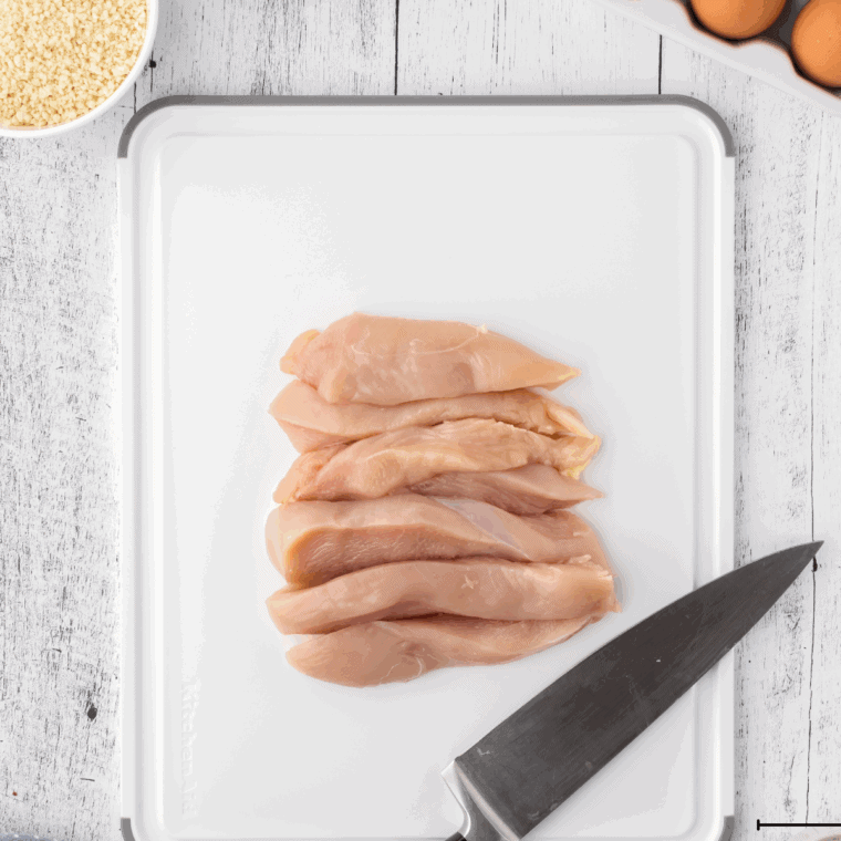 Chicken pieces soaking in buttermilk in a bowl to tenderize and lock in moisture.