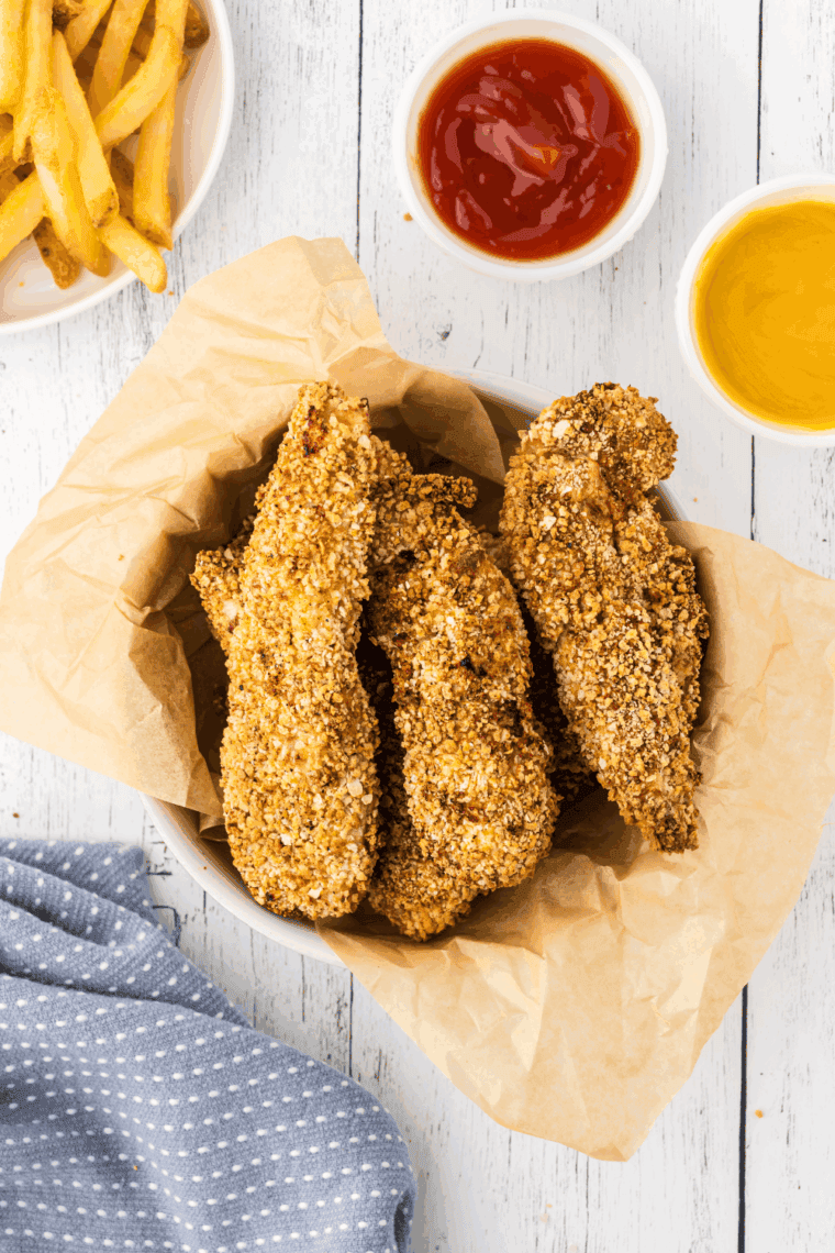 Golden crispy Arthur Treacher’s style fried chicken served on a plate with dipping sauce.