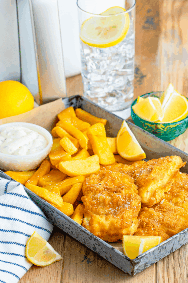 Small bowl of Arthur Treacher’s tartar sauce with a spoon, served next to crispy fried fish and golden fries.