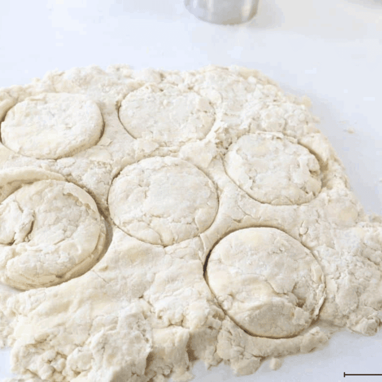 Patting dough on a floured surface to about 1-inch thickness and cutting biscuits with a round cutter without twisting.