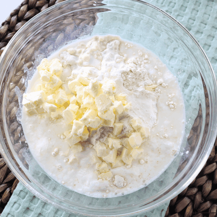 Whisking flour, baking powder, baking soda, and salt together in a large mixing bowl.