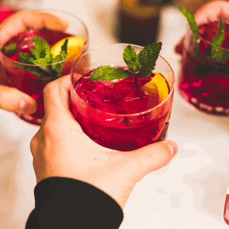 Colorful Red Lobster-style sangria served in a glass with fresh orange, lemon, and berries garnish.