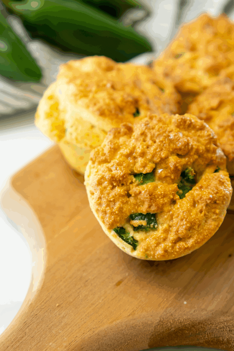 Golden crispy Captain D’s hush puppies with jalapeños served on a rustic plate.