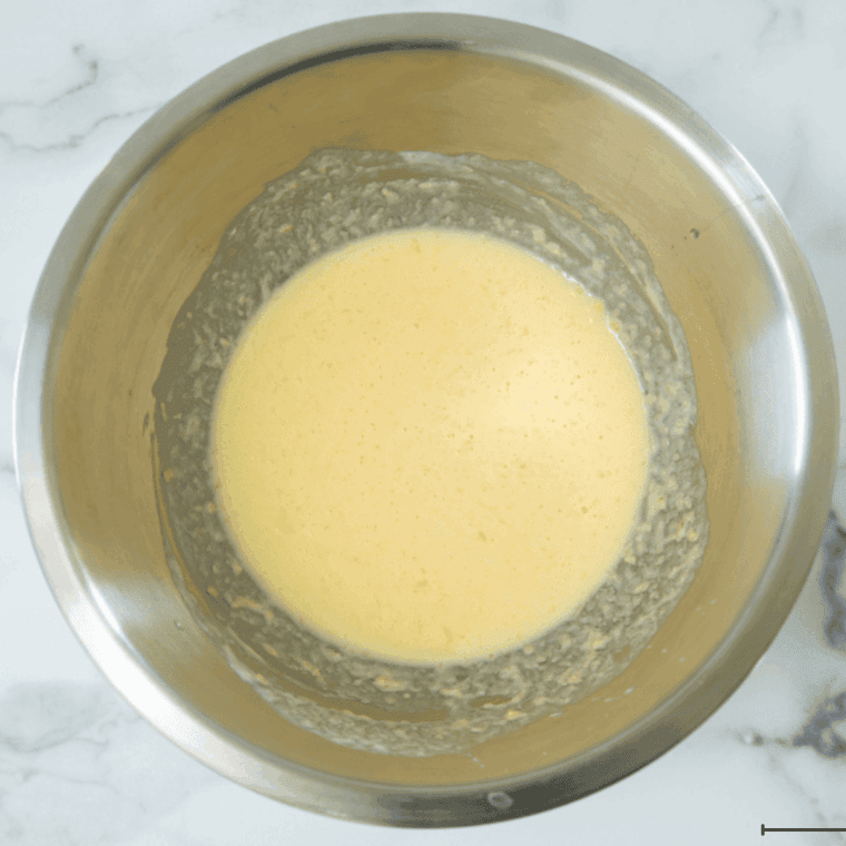 Stirring wet ingredients into dry mix to create hush puppy batter