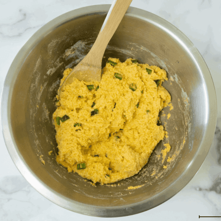 Scooping hush puppy batter into small even balls for air frying