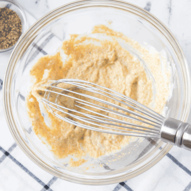 Mixing the ingredients in a large mixing bowl.