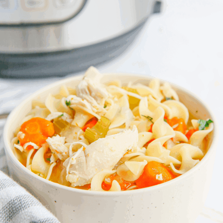 Bowl of Carrabba’s Spicy Sicilian Chicken Soup with shredded chicken, vegetables, and pasta in a rich broth.