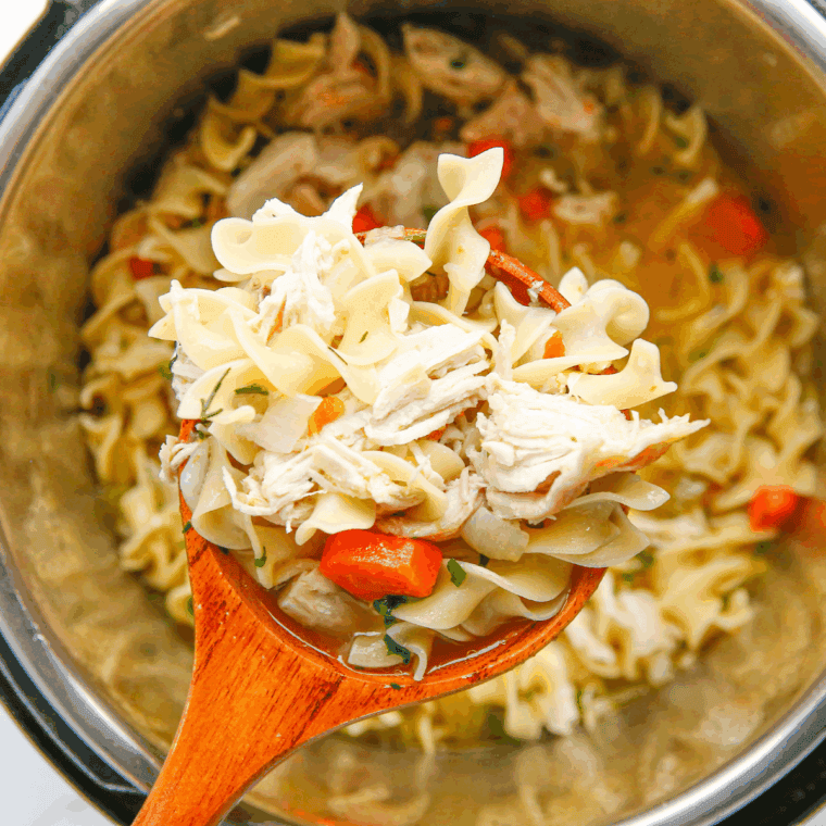 Bowl of Carrabba’s Spicy Sicilian Chicken Soup with pasta, shredded chicken, and vegetables in a rich, flavorful broth.
