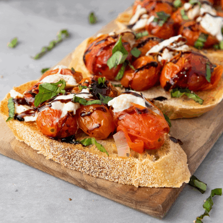 Carrabba’s Tomato Caprese with fresh burrata, roasted cherry tomatoes, and balsamic glaze served with crostini.