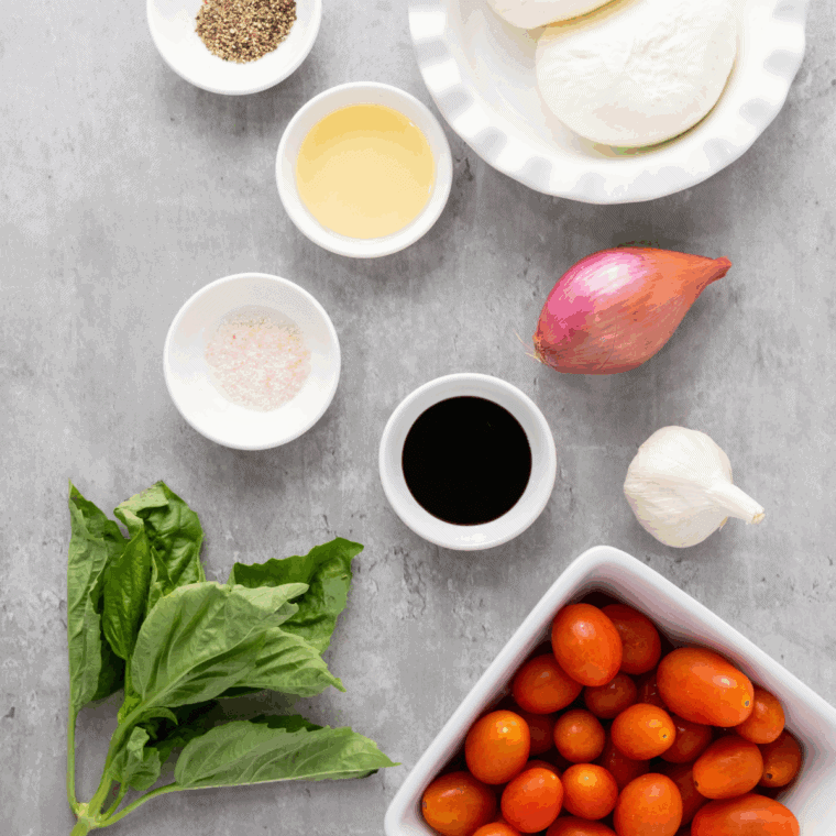 Ingredients needed for Carrabba's Tomato Caprese With Fresh Burrata Recipe on kitchen table.