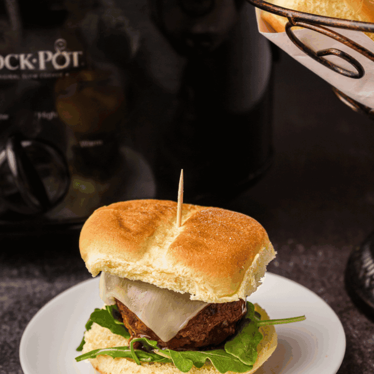 Baking dish filled with Cheesecake Factory copycat meatball sliders topped with melted mozzarella cheese.