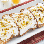 Ricotta cheese toast topped with honey and fresh berries on sourdough bread.