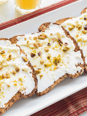 Ricotta cheese toast topped with honey and fresh berries on sourdough bread.