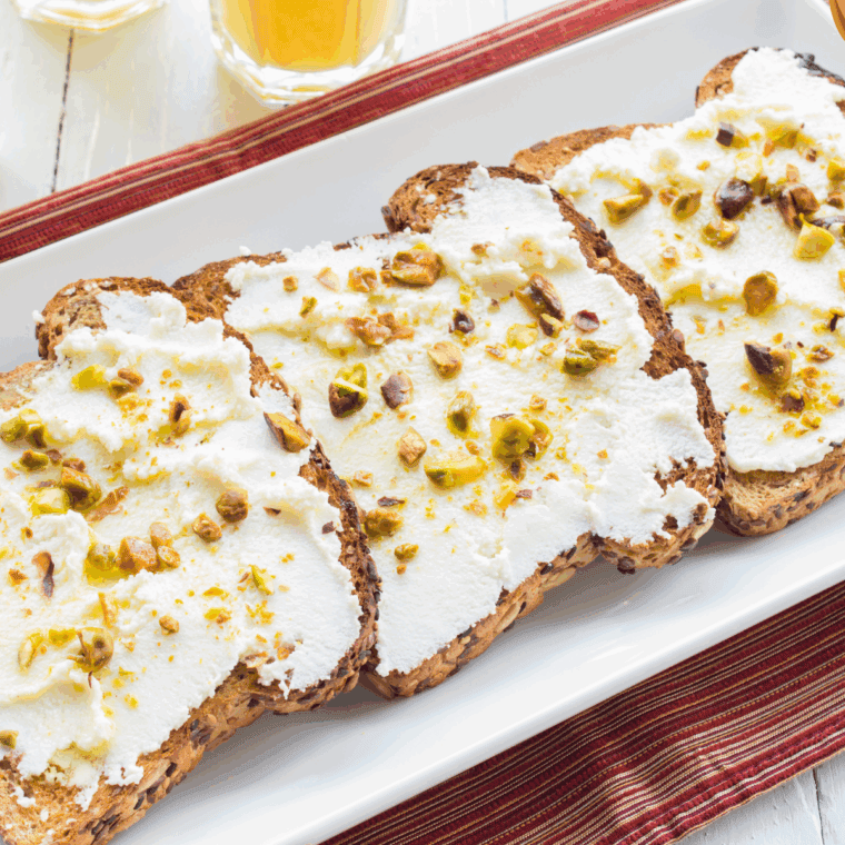 Ricotta cheese toast topped with honey and fresh berries on sourdough bread.