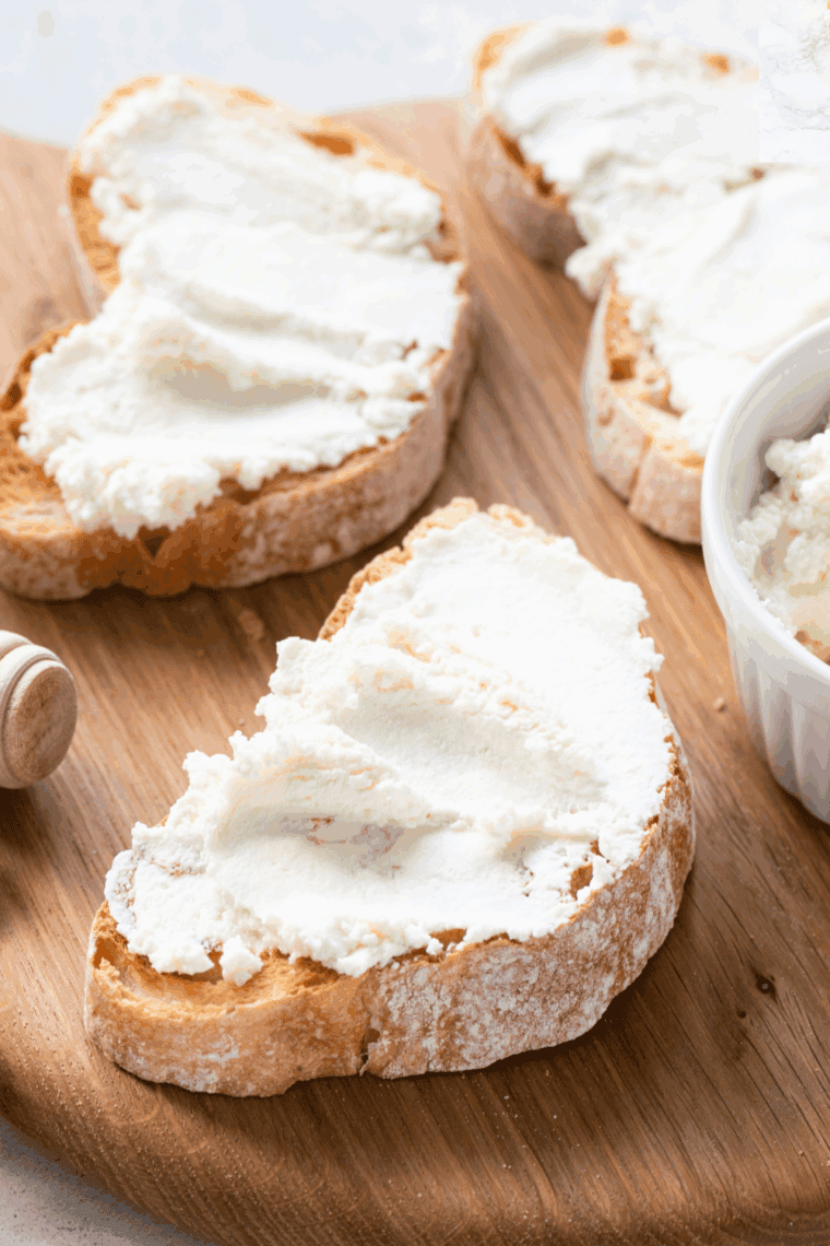 Slice of Cheesecake Factory-style ricotta cheese toast topped with fresh berries and honey.