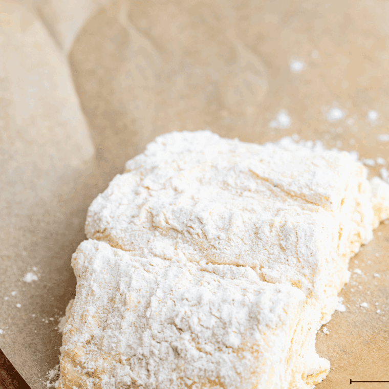 White fish fillets being patted dry with paper towels and seasoned with salt and pepper.