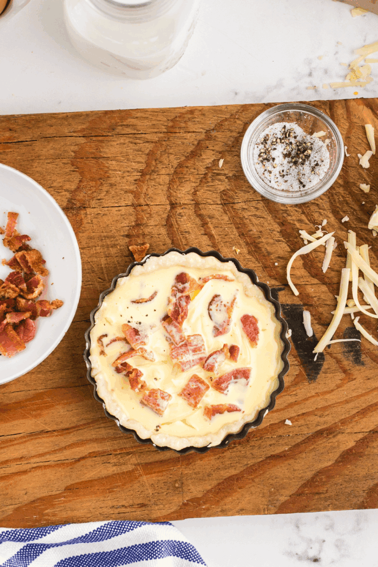 Assembled Copycat Cracker Barrel Bacon & Cheddar Quiche Recipe on kitchen counter.