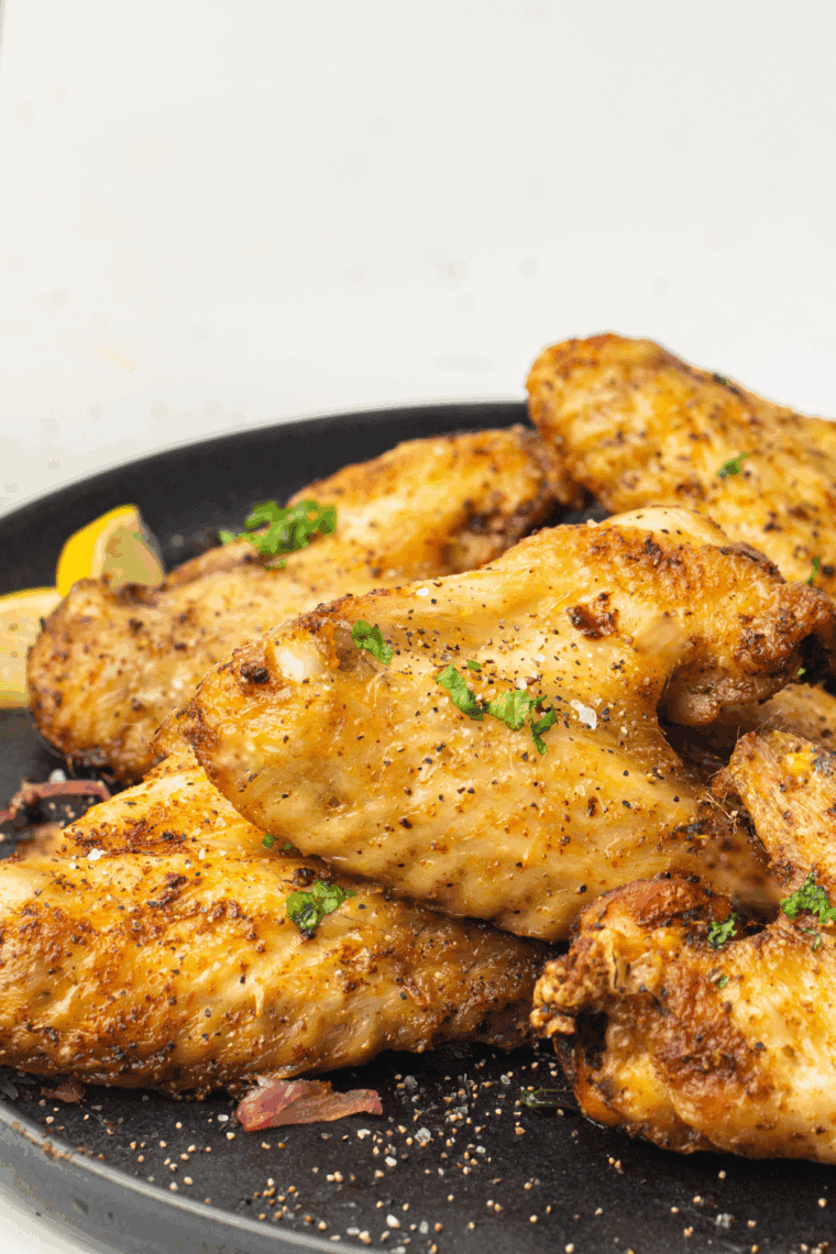 Homemade Copycat LongHorn Steakhouse wings served on a platter with dipping sauce