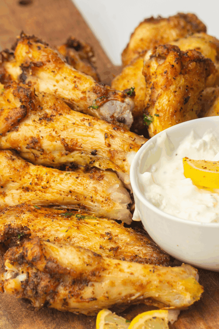 Homemade Copycat LongHorn Steakhouse wings served on a platter with dipping sauce