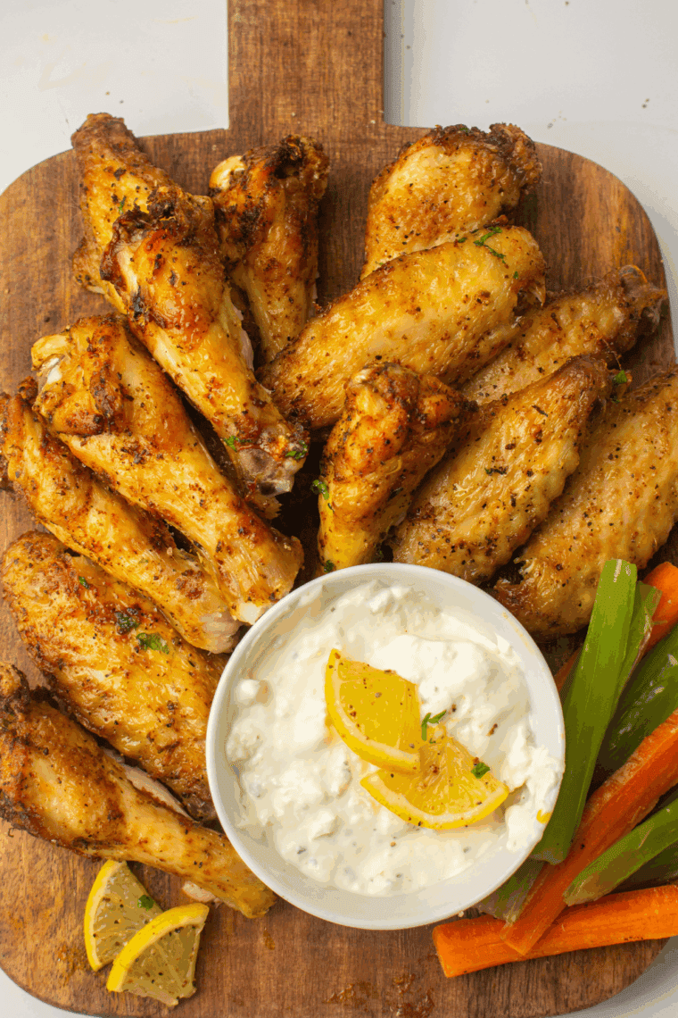 Homemade Copycat LongHorn Steakhouse wings served on a platter with dipping sauce