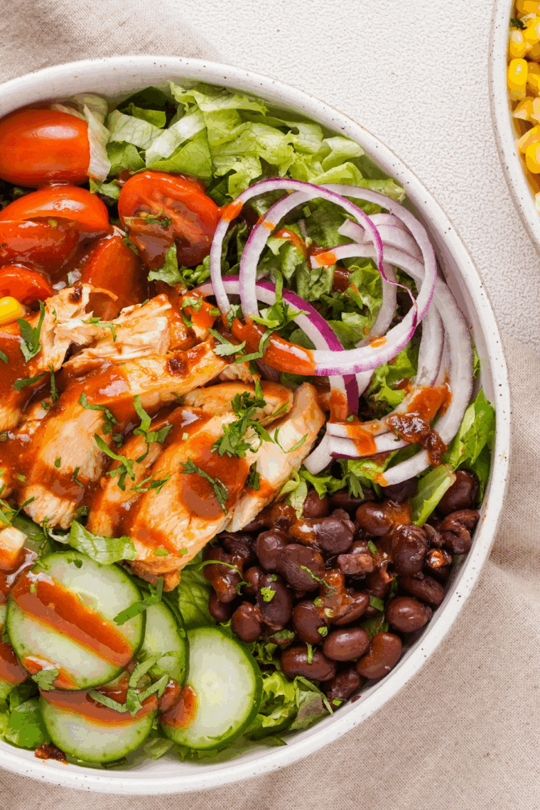 Homemade Copycat Panera BBQ Chicken Salad topped with grilled chicken, black beans, corn, pico de gallo, and crispy tortilla strips