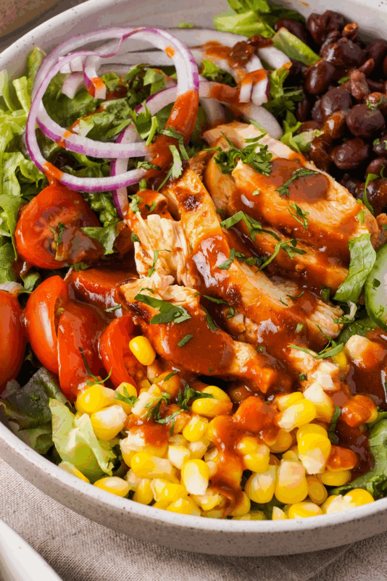 Copycat Panera BBQ Chicken Salad with grilled chicken, black beans, corn, cheddar cheese, and ranch dressing in a bowl