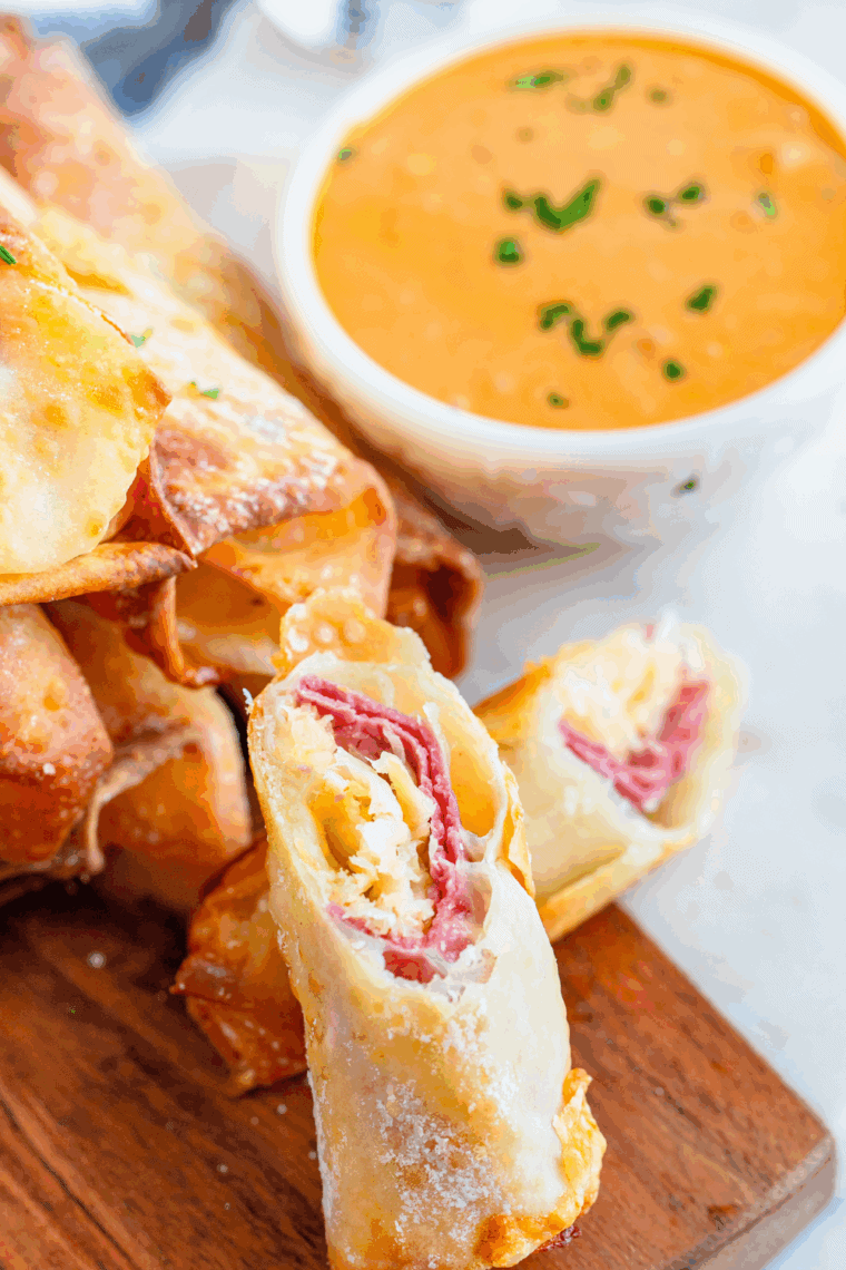Creamy dipping sauce paired with blistered shishito peppers on a serving platter