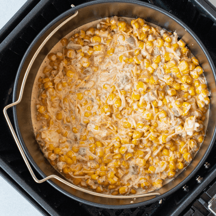 Mexican Street Corn Casserole spread in a baking dish, golden and bubbly after baking.