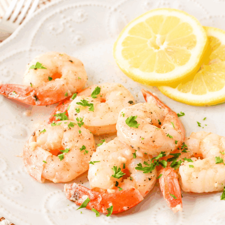 Close-up of Easy Shrimp Scampi with garlic butter sauce served over pasta, no wine used in recipe.