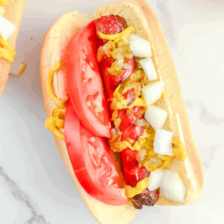 Five Guys-style grilled hot dogs in toasted buns with ketchup, mustard, and toppings.
