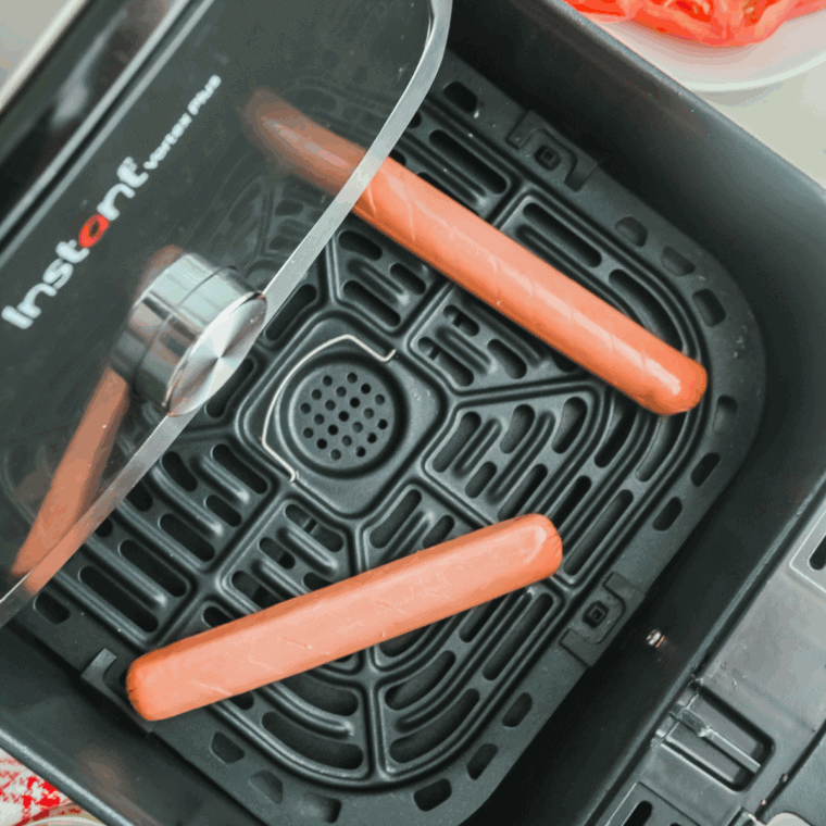 Place raw hot dogs into the air fryer basket.