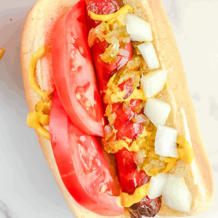 Five Guys-style grilled hot dogs in toasted buns with ketchup, mustard, and relish.