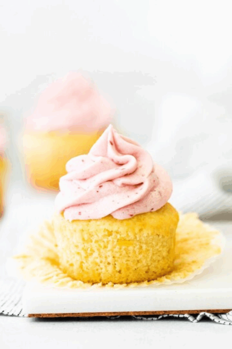From scratch lemon raspberry cupcakes with creamy frosting topped with fresh raspberries and lemon zest.